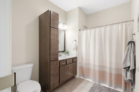 a bathroom with a shower and a toilet and a sink