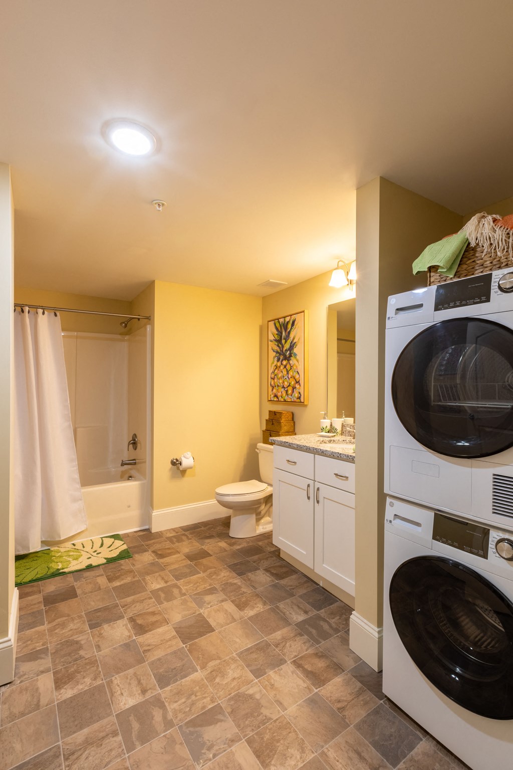 a bathroom with a washer and dryer in it and a toilet and sink
