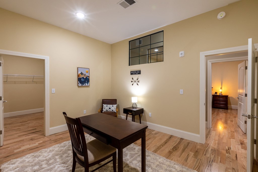 a dining room and living room with a table and chairs