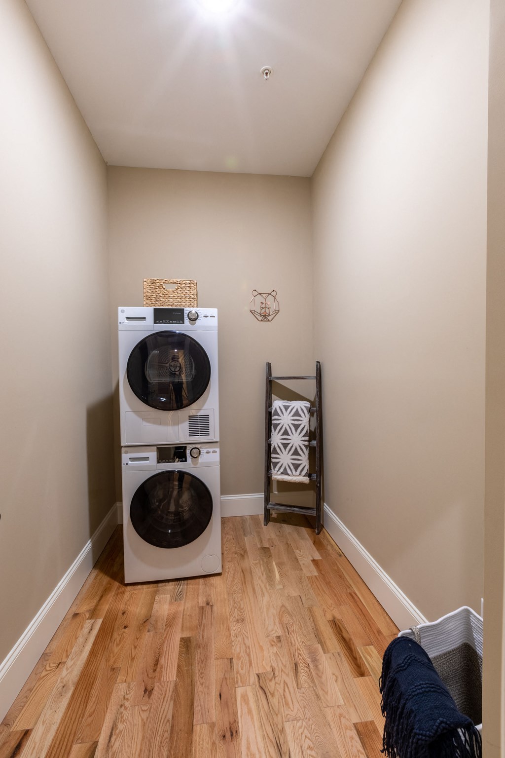 a washer and dryer in a laundry room with a wooden floor