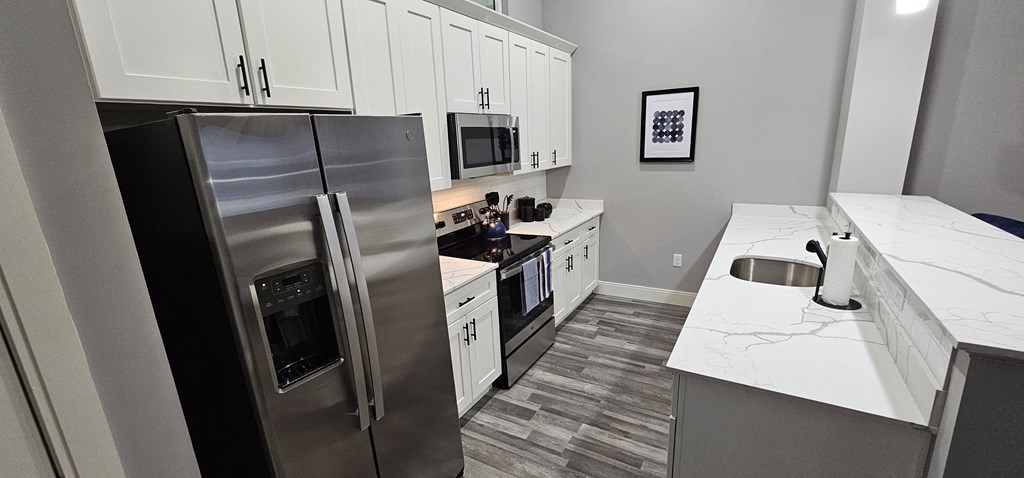 a kitchen with stainless steel appliances and white cabinets
