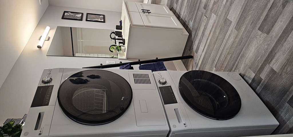 a washing machine and a dryer in a room