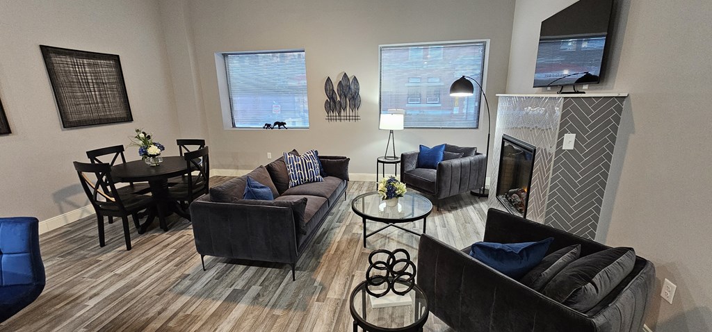 a living room with couches and a table and a fireplace