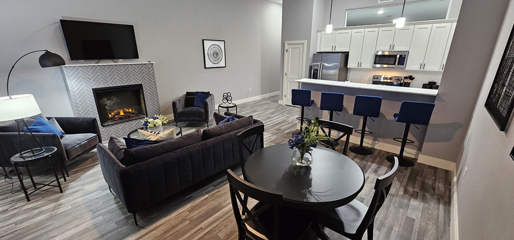 a living room with a fireplace and a table and chairs