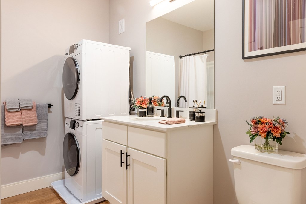 A white washer and dryer in a laundry room.