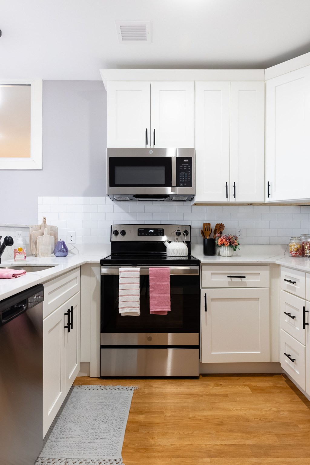 A modern kitchen with a stove top oven and microwave above it.