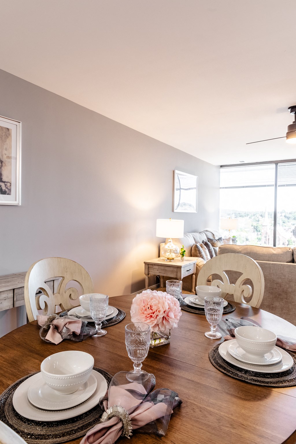 a dining room table set with plates and glasses