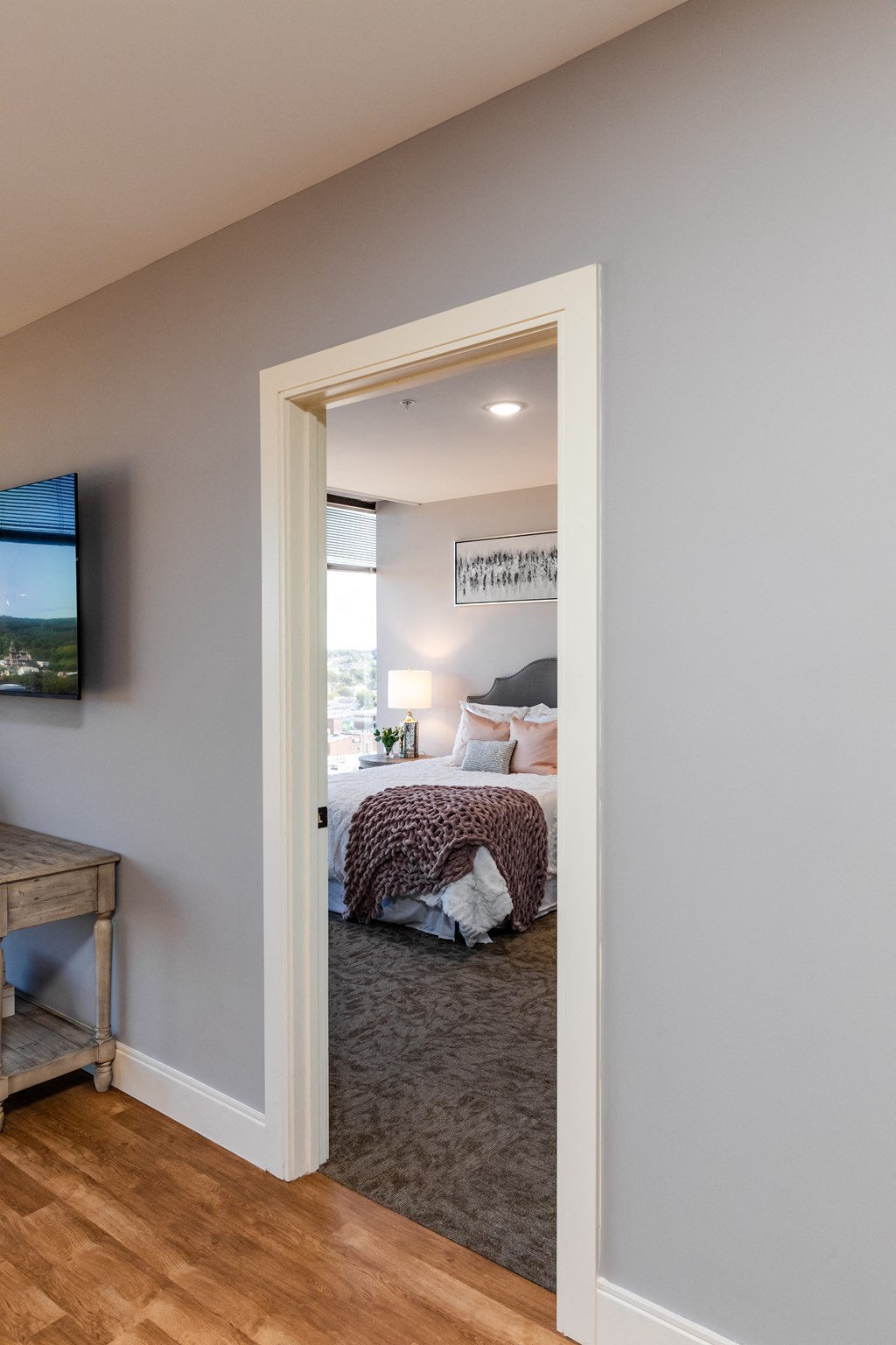 a bedroom with a bed and a tv in a 555 waverly unit