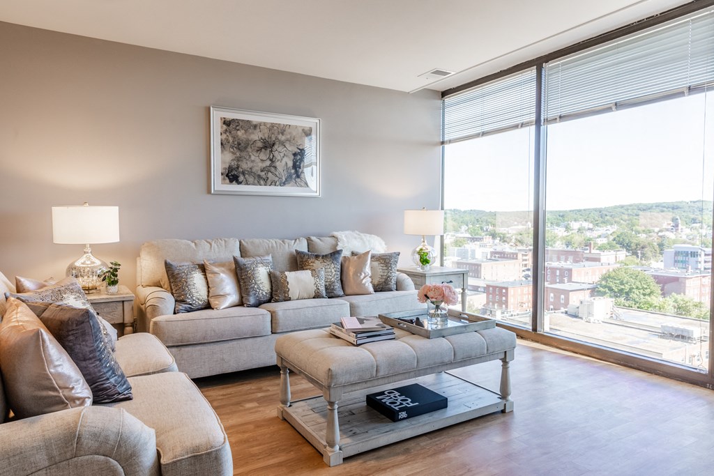 a living room with a large window and a view of the city