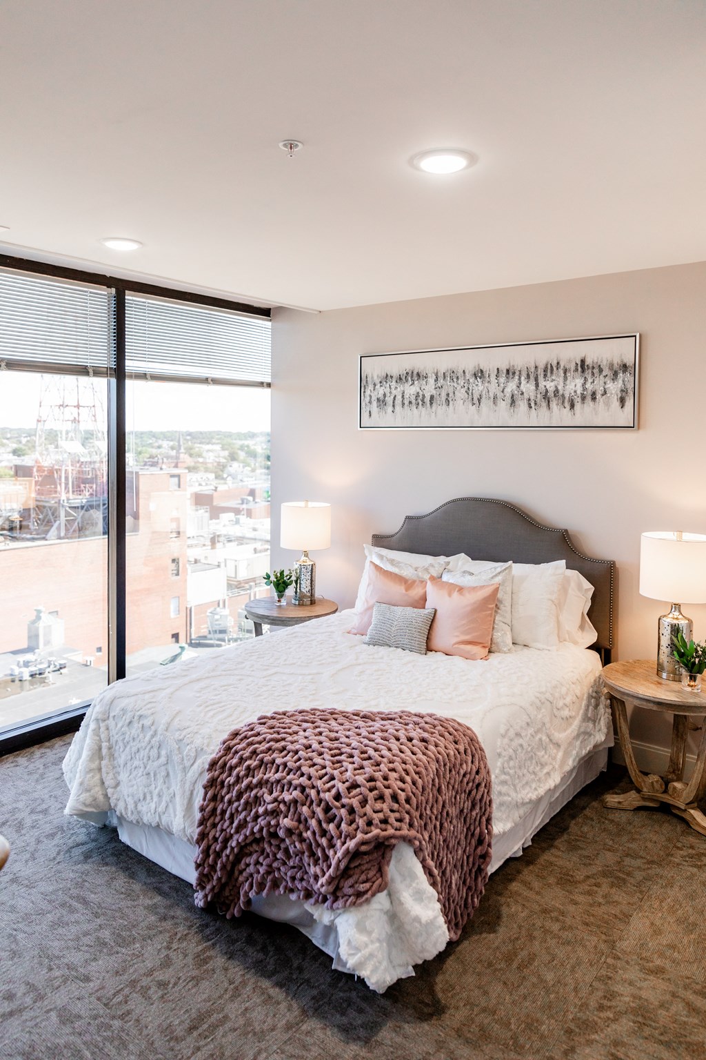 a bedroom with a large bed and a large window