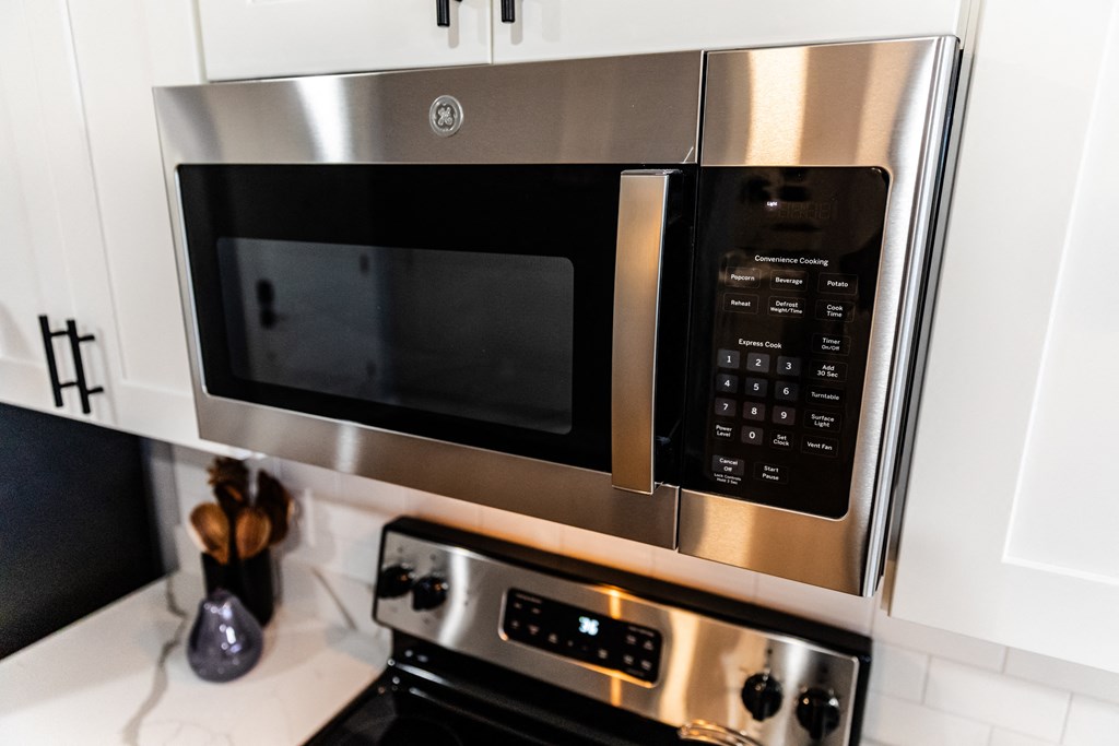 a kitchen with a stainless steel microwave and oven