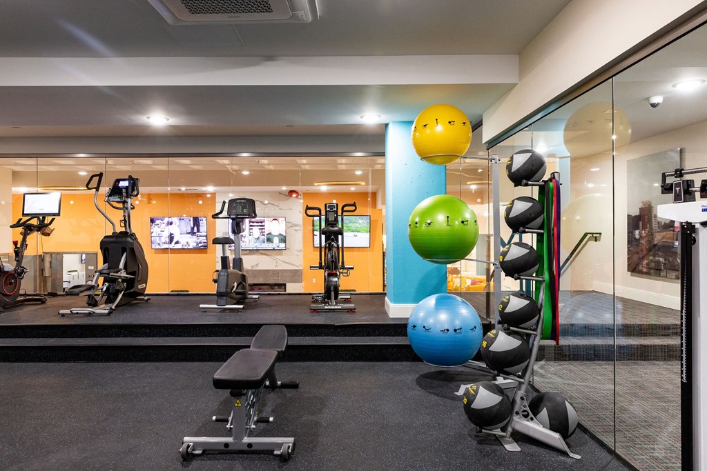 a gym with weights and balls and other exercise equipment