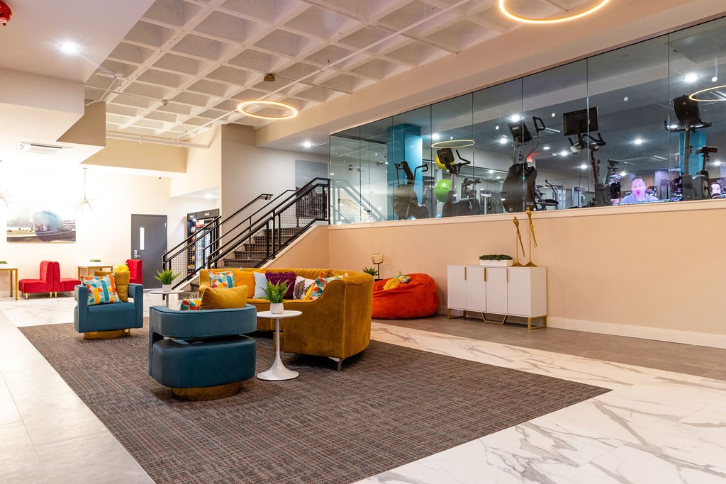 a lobby with couches and chairs and a staircase