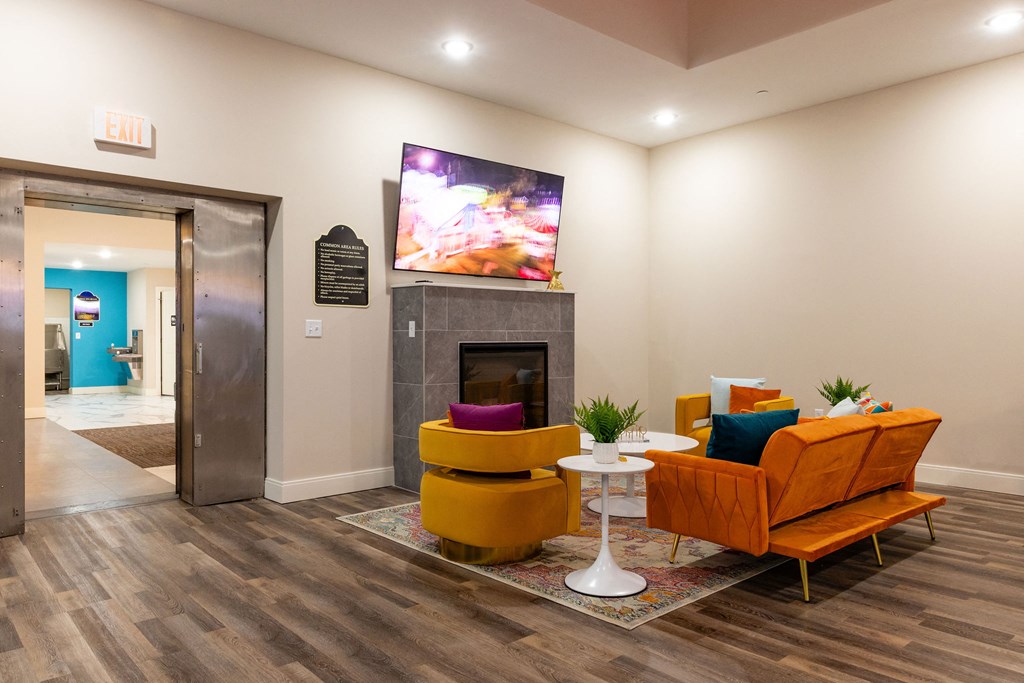 a living room with a fireplace and a tv