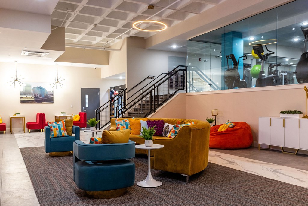 a lobby with couches and chairs and a staircase