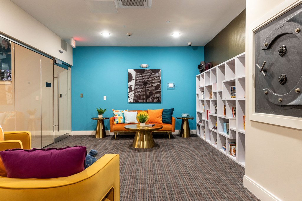a living room with a blue wall and yellow furniture