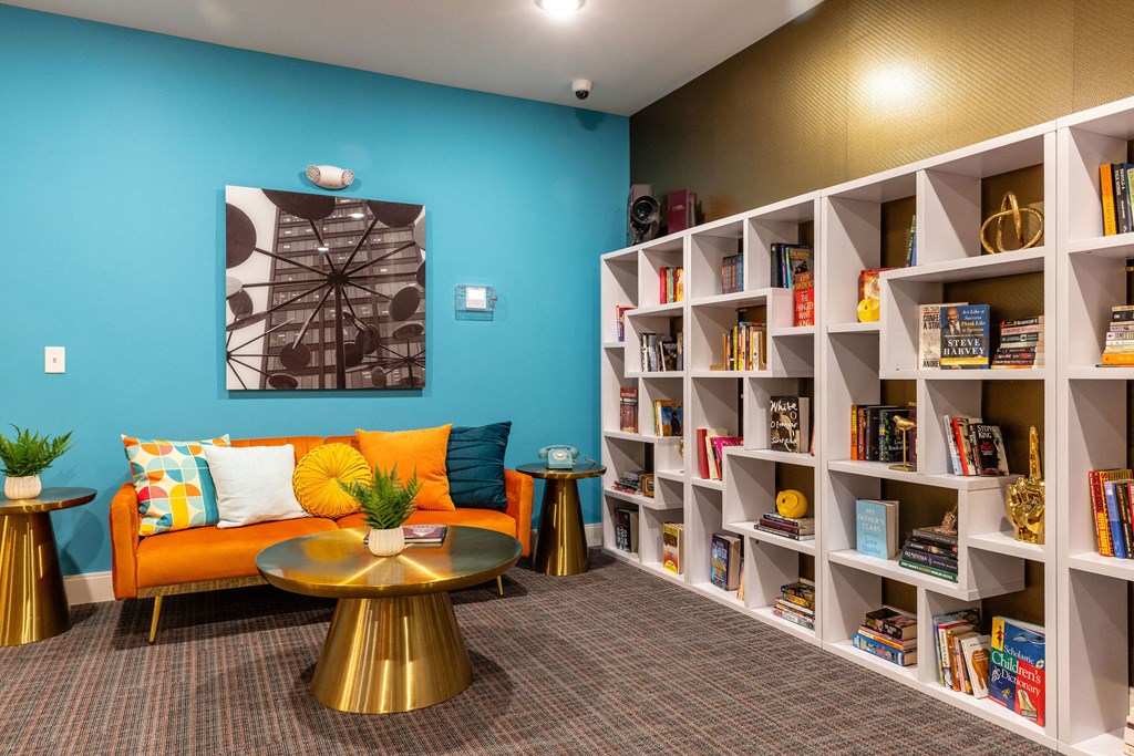 the lobby of a library with a couch and tables