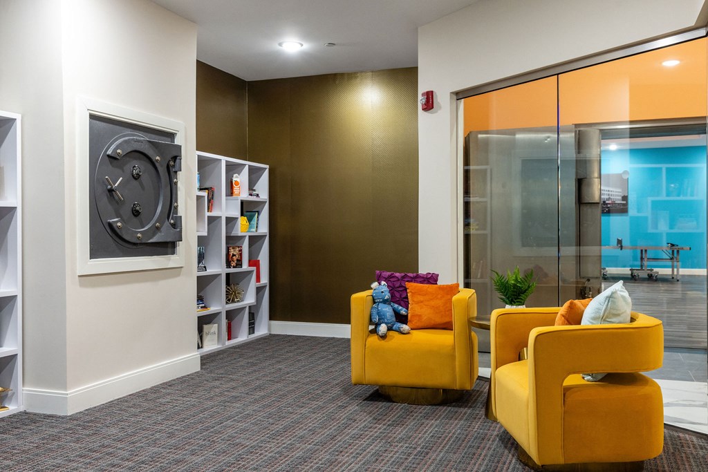 a living room with yellow chairs and a television
