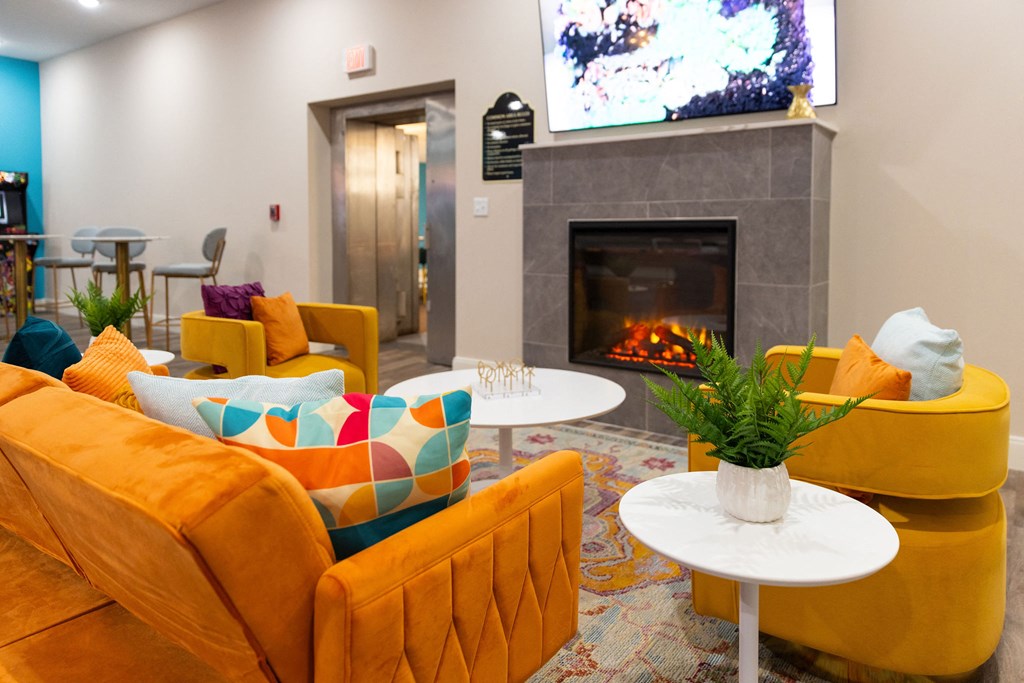 a living room with couches and chairs and a fireplace