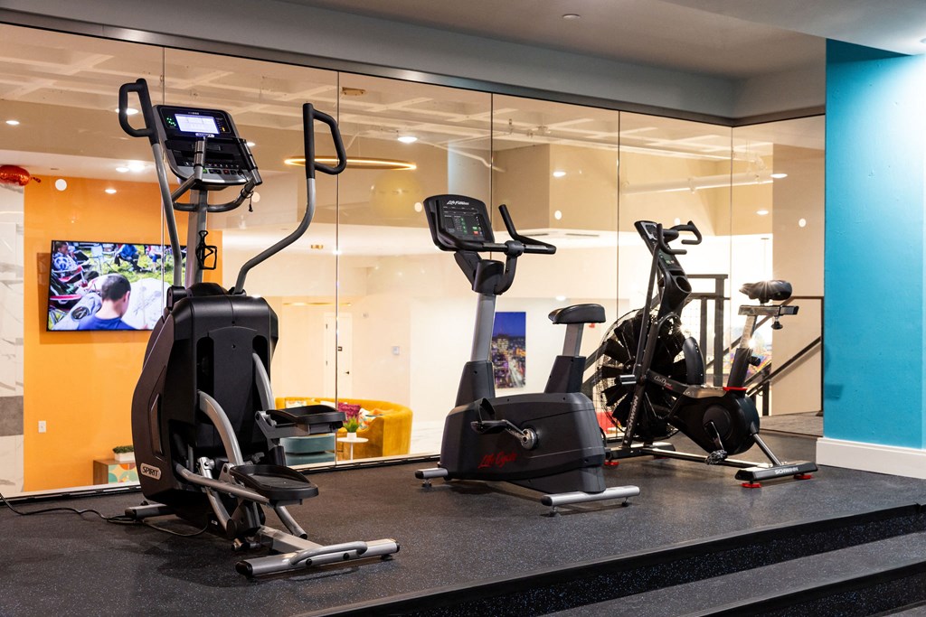 a gym with exercise equipment in the lobby of a building