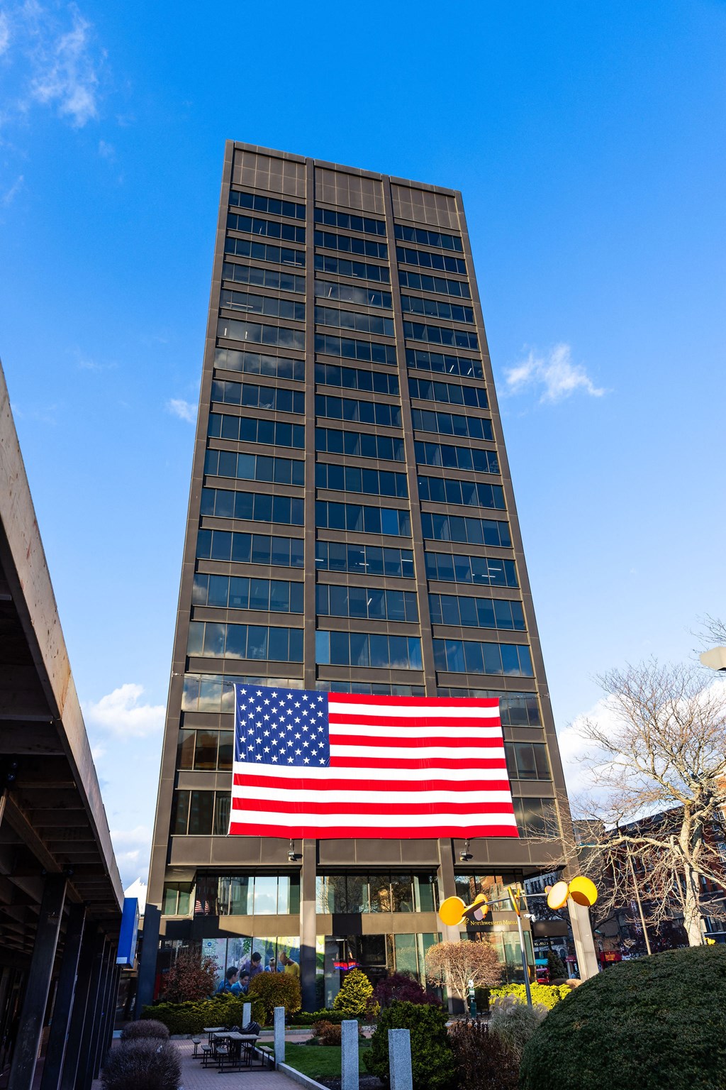 a large flag in front of a tall building