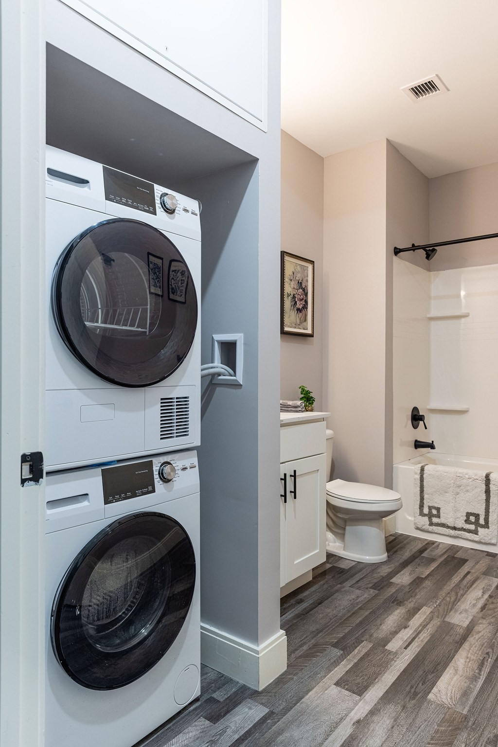 A white washer and dryer in a small laundry room.