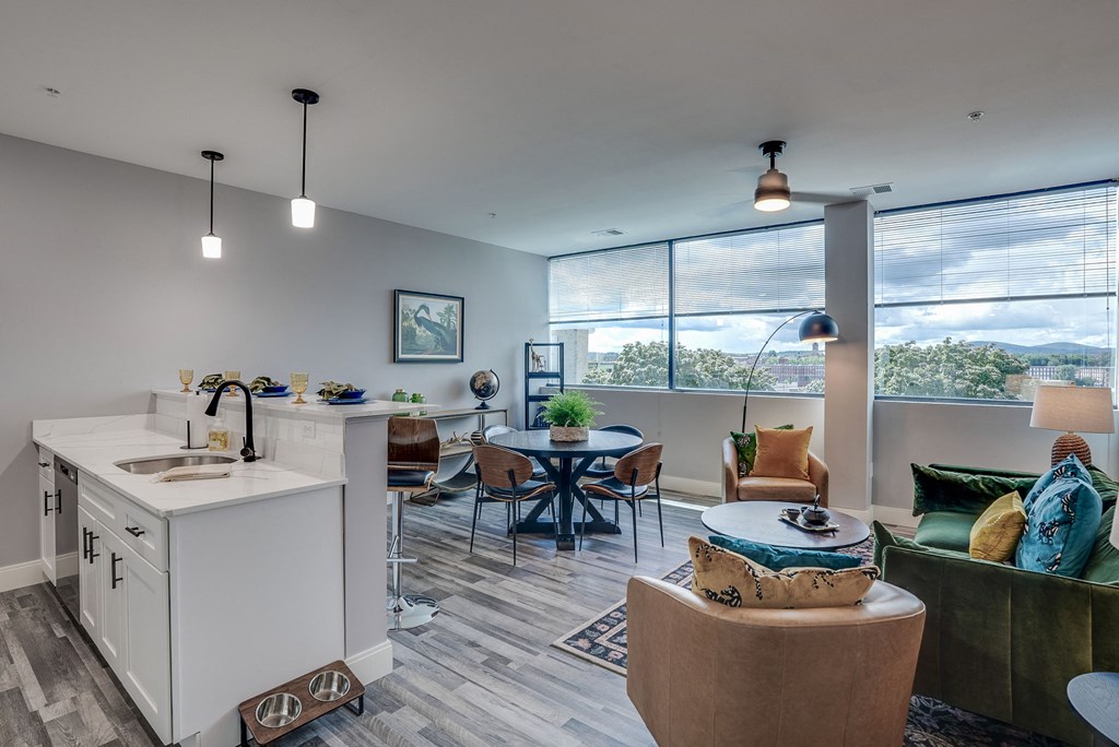 an open living room with a kitchen and a dining room
