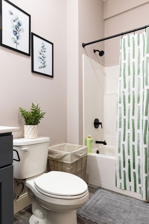 A white toilet sits next to a white sink in a bathroom.
