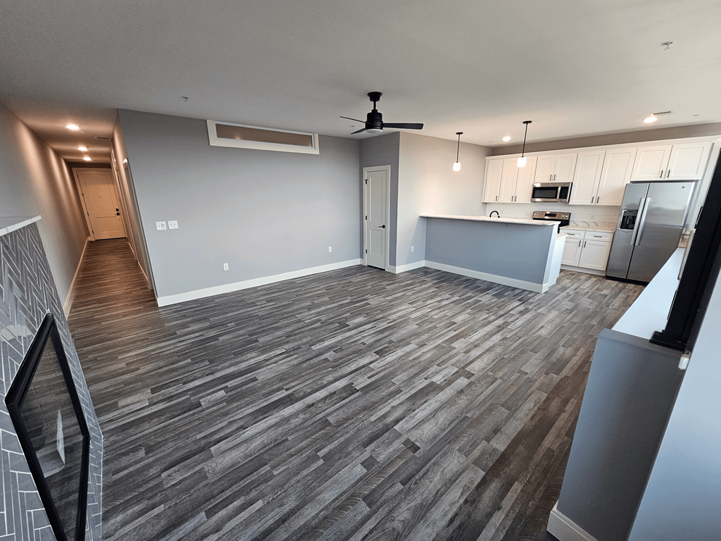 a renovated living room and kitchen in a new home