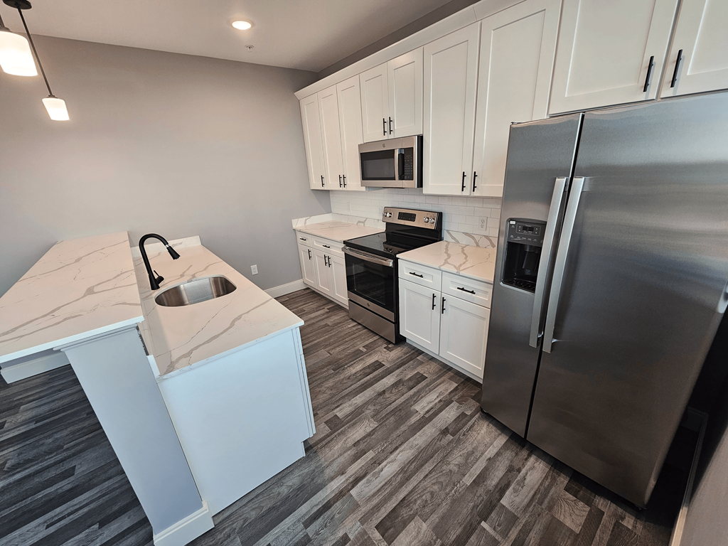 a kitchen with stainless steel appliances and white cabinets