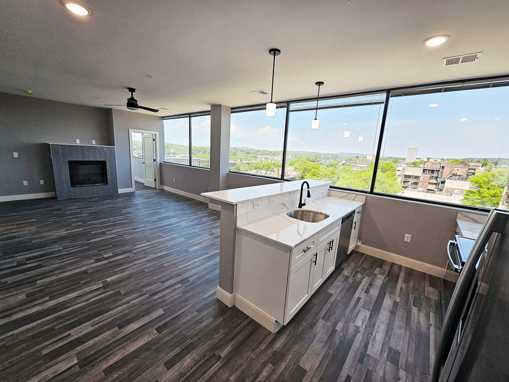 a kitchen and living room with a view of the city