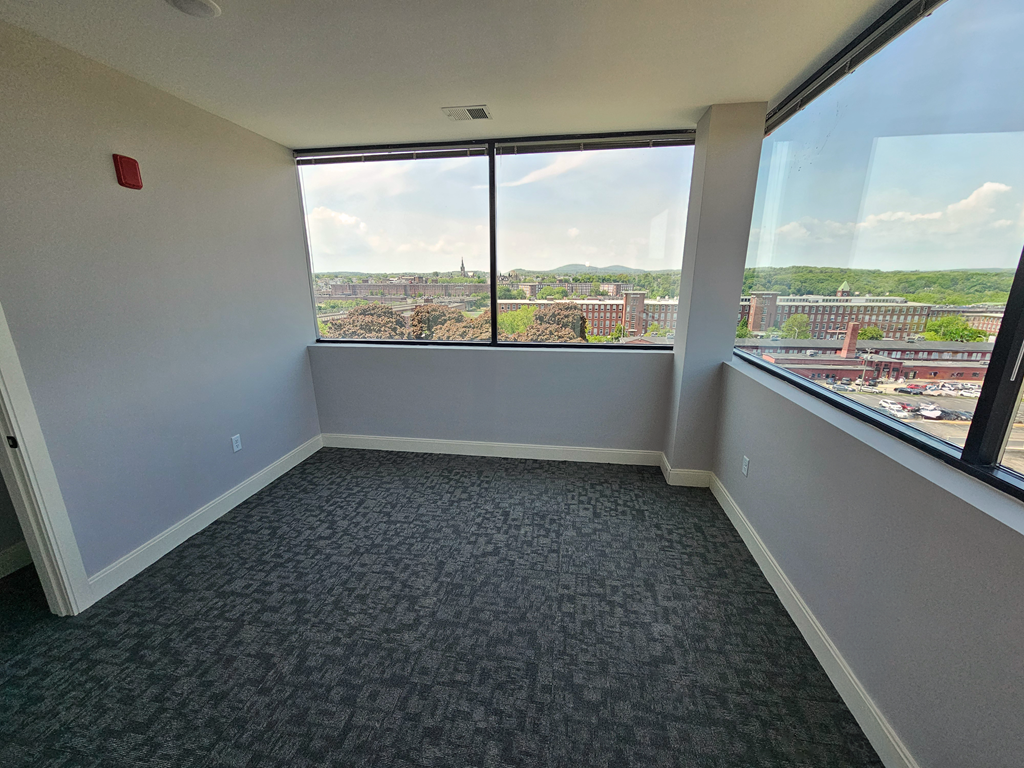 an empty room with a view of a city