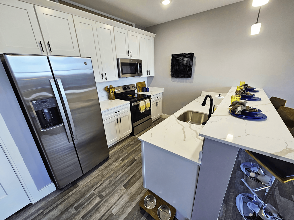 a kitchen with stainless steel appliances and a white counter top