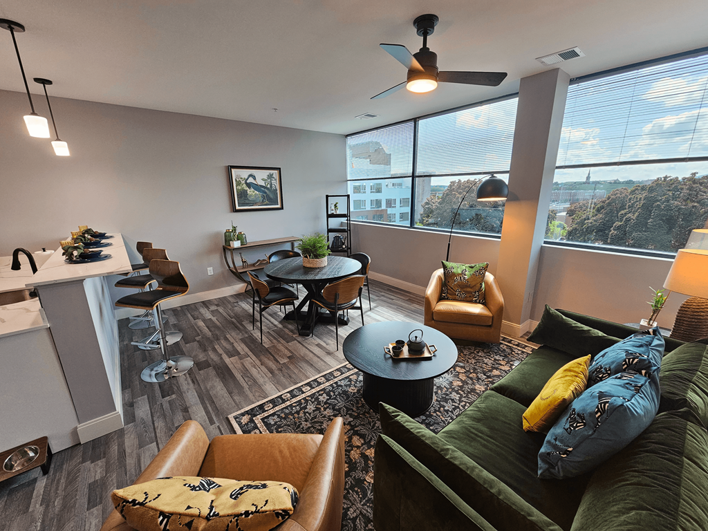 a living room with a couch and chairs and a table