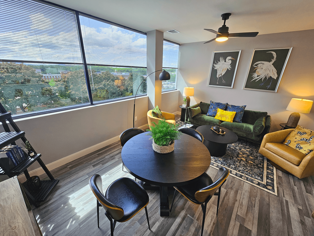 a living room with a large window and a table