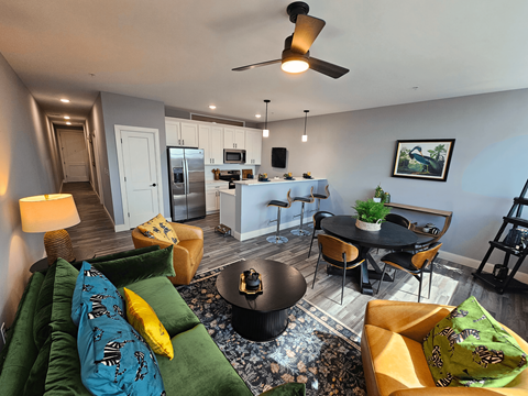 a living room and kitchen with a couch and a table