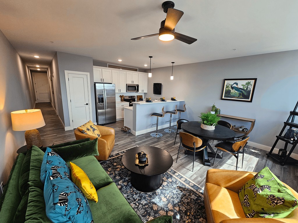 a living room and kitchen with a couch and a table