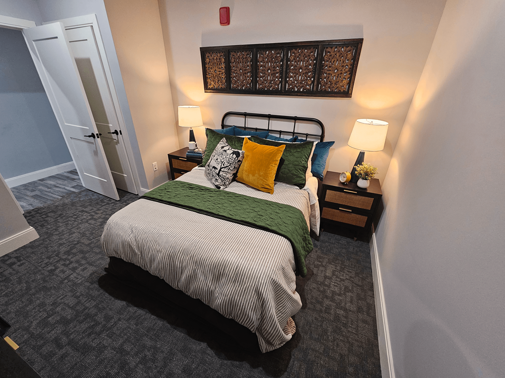 a bedroom with a bed and a door to a closet