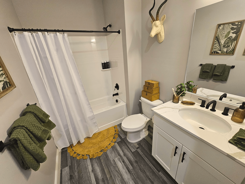 a bathroom with a shower and a sink and a toilet