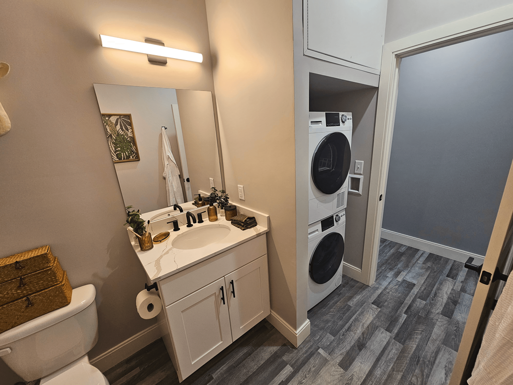 a bathroom with a toilet sink and a washing machine