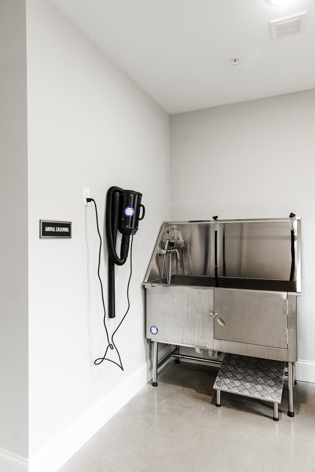 a phone and a stainless steel refrigerator in a room