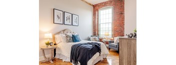 a bedroom with a bed and a chair