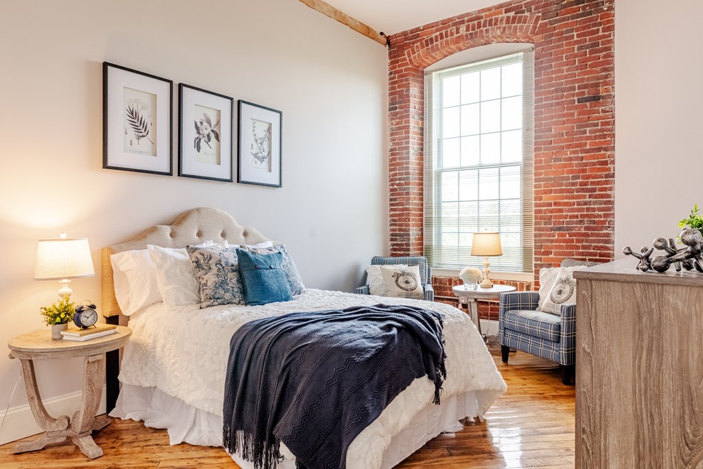 a bedroom with a bed and a chair