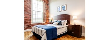 a bedroom with a bed and two nightstands