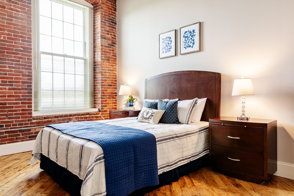 a bedroom with a bed and two nightstands