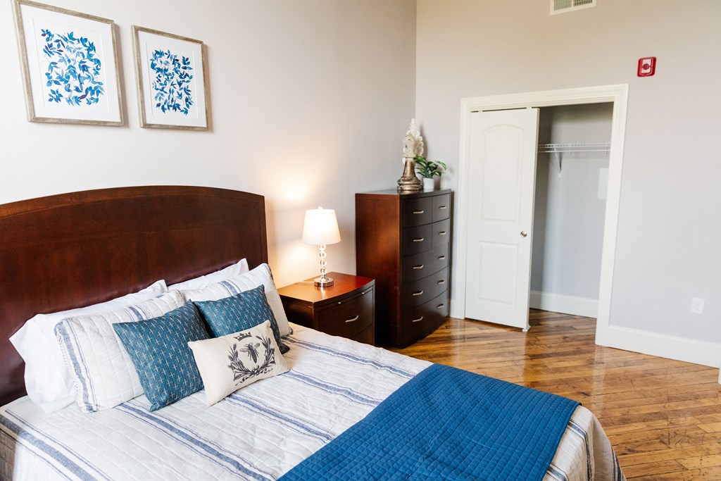 a bedroom with a bed and a dresser