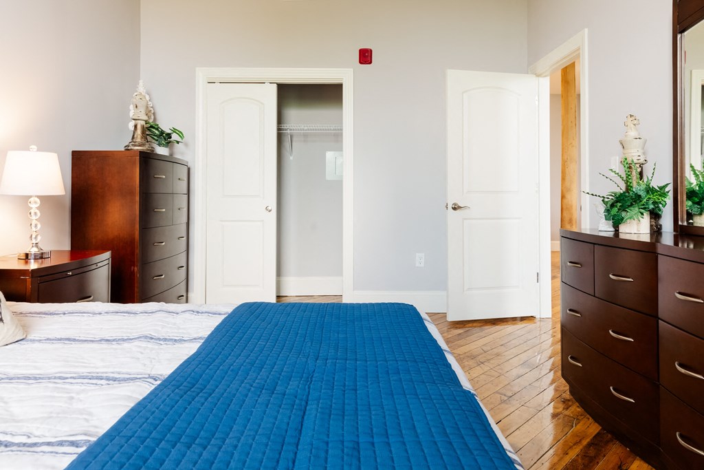 a bedroom with a bed and dresser