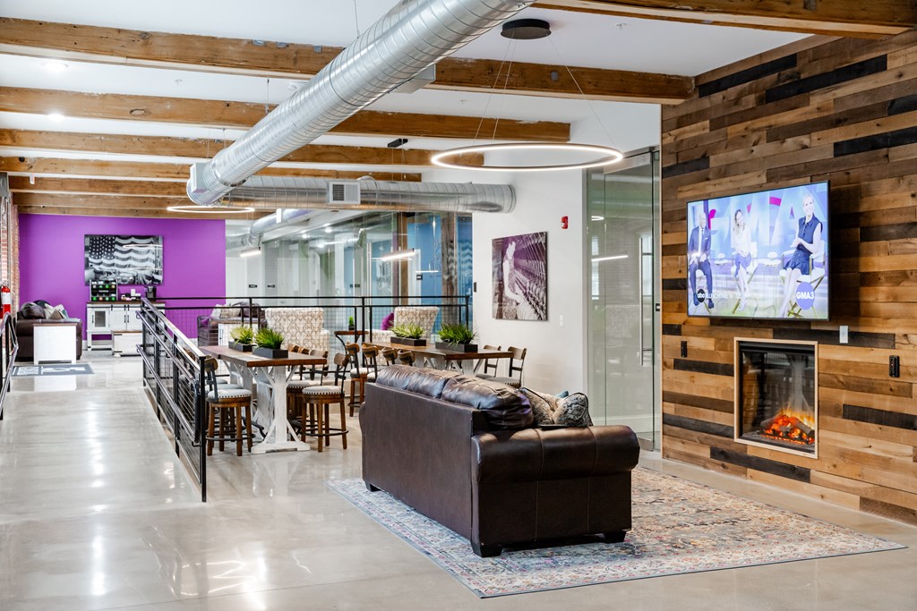 a living room with a fireplace and a table with chairs