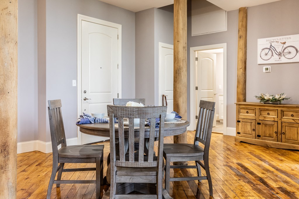 a dining room with a table and four chairs