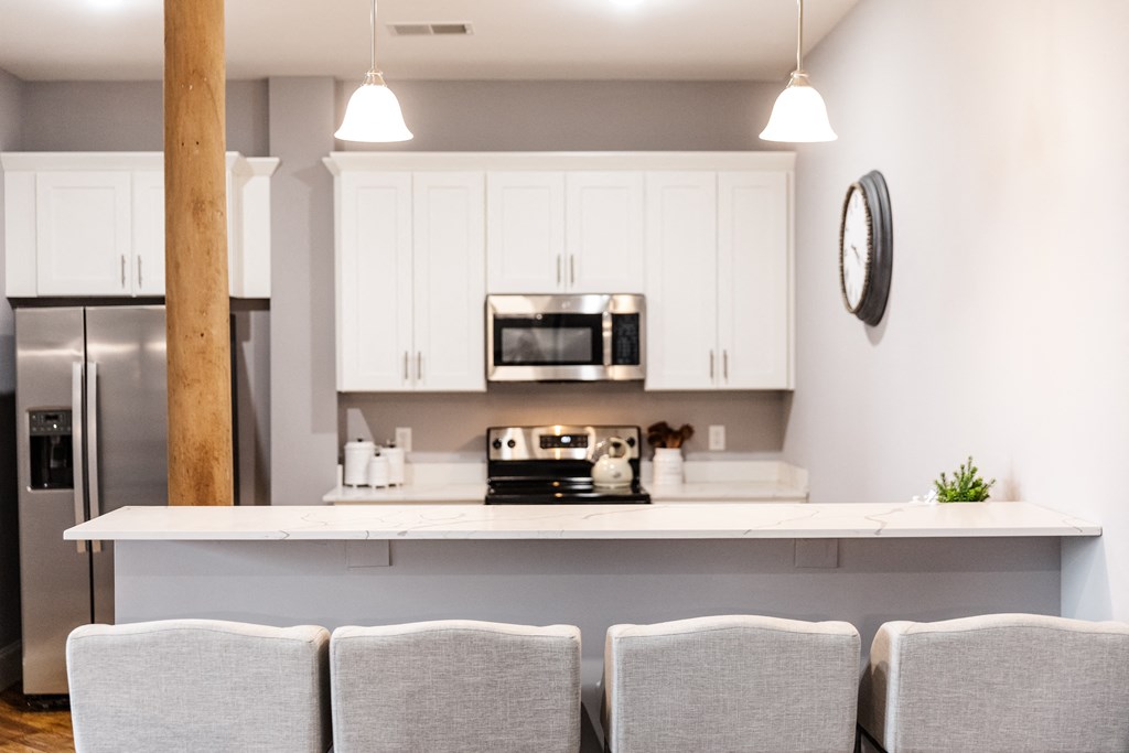 a kitchen with white cabinets and a white counter top